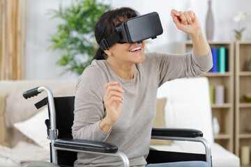 disabled woman in a wheelchair at home uses vr helmet