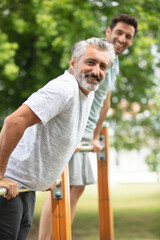 two strong and competitive men exercising outdoors