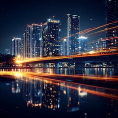Fototapeta premium City skyline at night with illuminated bridge and reflections.
