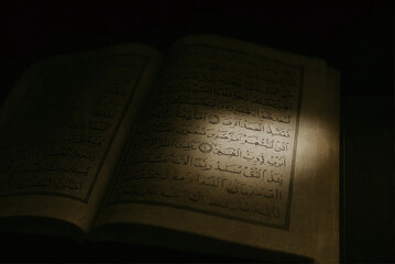 Beam of Light Illuminating Quranic Verses – Dramatic Islamic Concept Photo