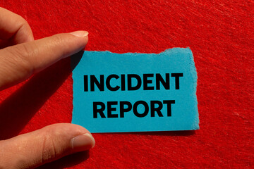 Incident report message written on ripped torn blue paper on red background. Conceptual incident...