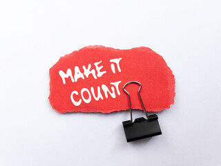 Make it count message written on ripped torn red paper piece on white background. Conceptual make...