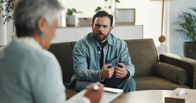 Therapy, talking and man with therapist in office for consulting, advice and emotional support. Psychology, mental health and woman with clipboard for patient for writing notes, counseling or session