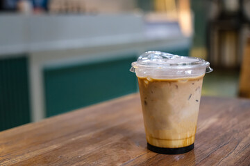 Iced Coffee in Plastic Cup on Wooden Table
