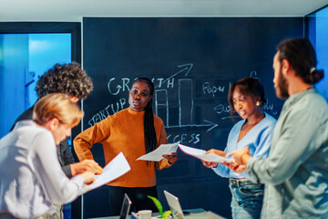 Startup team discussing growth strategies during office meeting