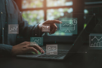 Businessman analyzing data dashboard with futuristic digital interface in modern office.