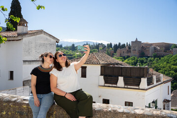 Tourists enjoying a selfie with alhambra in the background