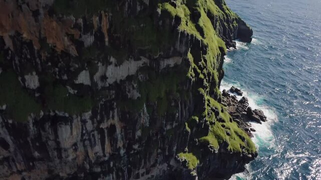 Powerful ocean waves crashing against rugged faroe islands cliffs, revealing dramatic seascape with wild north atlantic landscape and dynamic natural forces