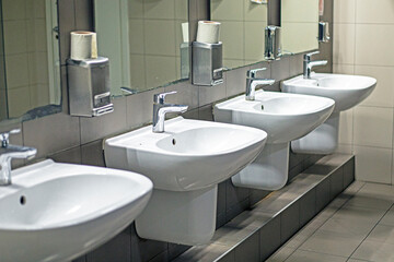 hand and face wash basins in a public toilet in a mall