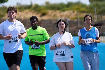 Athletes running a race on a blue track