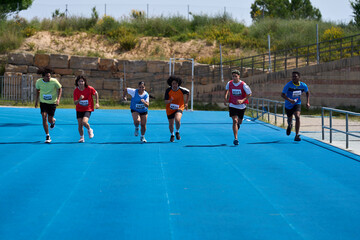 Athletes running on blue track during competition