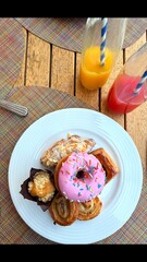 Pastry plate glows with pink donut, golden swirls, flaky layers and soft muffin, sprinkled frosting...