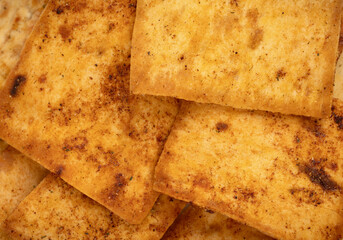Nacho chips texture. Tortilla chips. Taco chips. Close-up. Food background. Tasty snack. Group of crispy corn chips isolated on white background.
