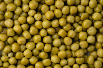 Fresh green peas background, texture of perfect peeled sweet pea grains as background. Vegetable background, vegetable protein, healthy products. Canned peas.