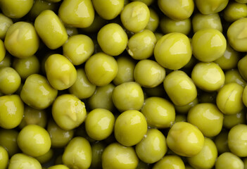 Fresh green peas background, texture of perfect peeled sweet pea grains as background. Vegetable background, vegetable protein, healthy products. Canned peas.