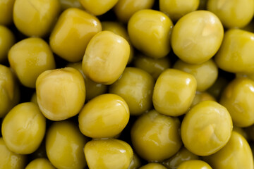 Fresh green peas background, texture of perfect peeled sweet pea grains as background. Vegetable background, vegetable protein, healthy products. Canned peas.