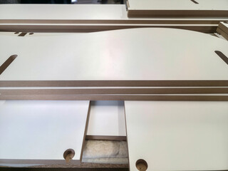 Woodworking process showcases precision-cut plywood sheets in a workshop setting during daytime