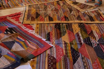 Beautiful berber carpets lying on floor in moroccan market.