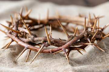 Crown of thorns on linen cloth symbolizing Jesus and the Passion in rustic style