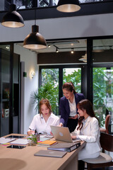 Asian Business Women Teamwork Collaboration in Modern Office Space Meeting on Laptop for Project Review and Discussion Professional Corporate Environment