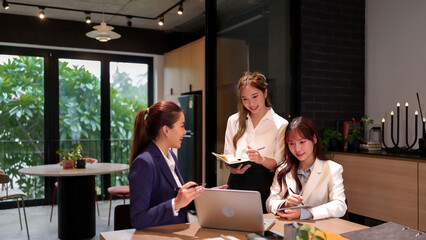 Asian Businesswomen Meeting in Modern Office Collaborative Project Discussion Teamwork Professional Women Smiling Using Laptop and Tablet Technology Coworking Space