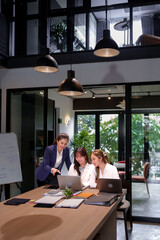 Asian Women Teamwork Collaboration on Laptop Computer in Modern Office Space Brainstorming...