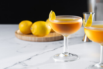 Paper plane cocktail on white marble and black background