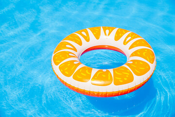 Colorful inflatable pool float in a sunny swimming pool