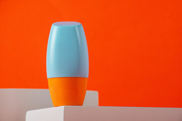 Blank tube with cosmetic product for moisturizing on orange background