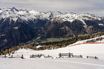 View of sunny winter in dolomites, alps. Pinzolo village and a ski resort in Italy. Dolomites Brenta, Adamello park and Presanella moutain, Doss del Sabion skiarea trentino Italy.