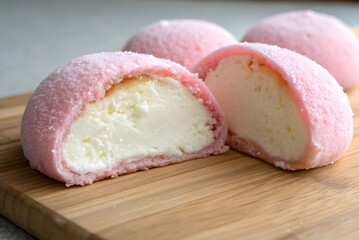 Soft Pink Dessert with Creamy Filling on Wooden Board, Ideal for Sweet Treats and Confectionery Photography