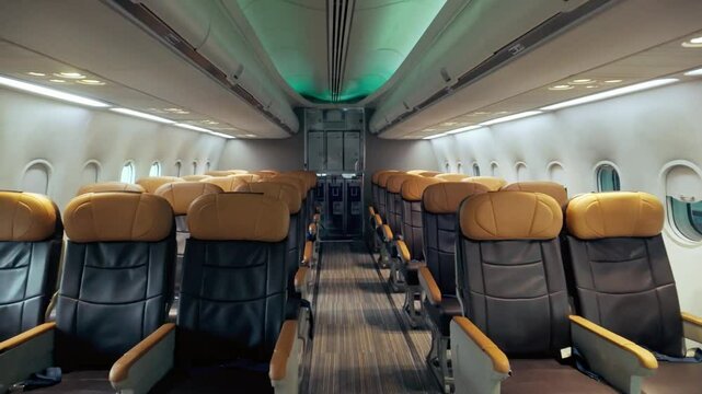Wide-angle view of a modern airplane cabin with empty leather seats, clean interior, and ambient lighting, ideal for illustrating airline comfort, business class travel, and aviation services.