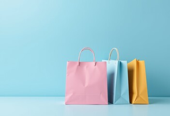 Three Shopping Bags in Pastel Colors on Blue Background
