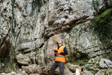 Drone Operator Surveying Rocky Canyon