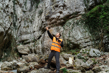 Drone Operator Surveying Rocky Canyon
