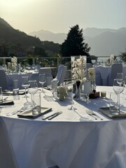 Beautifully set tables in the restaurant with a view of the mountains