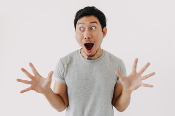 Shocked Asian man with open mouth and hands spread in disbelief