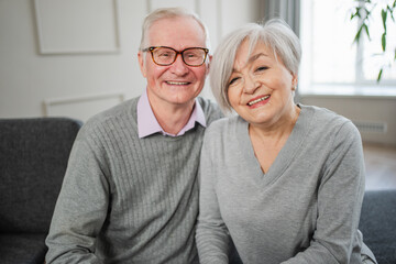 Senior adult mature couple hugging at home. Mid age old husband and wife embracing with tenderness love enjoying sweet bonding wellbeing. Grandmother grandfather together. Family moment love and care
