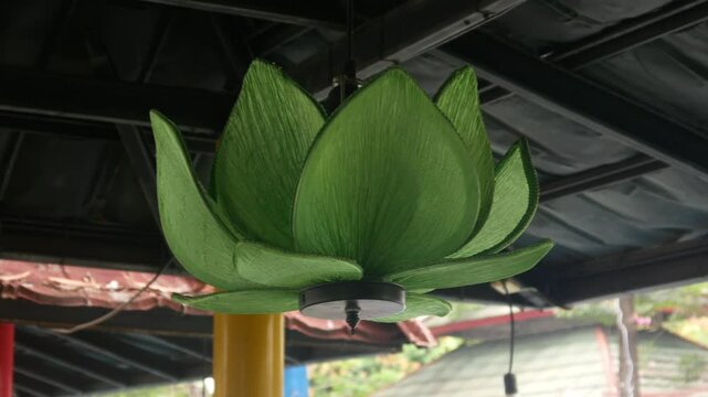 lotus flower shaped chandelier moving in the wind.