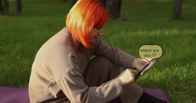 A disgruntled woman is sitting in a park waiting for a date and meeting, sending an SMS message with questions about the person's whereabouts High quality 4k footage