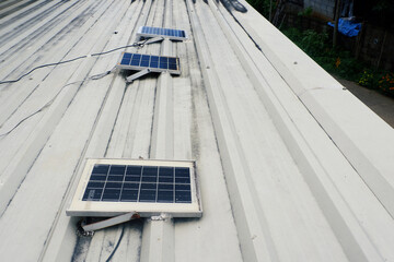 Small solar panels installed on a metal sheet roof