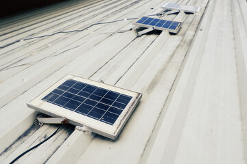 Small solar panels installed on a metal sheet roof