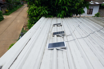 Small solar panels installed on a metal sheet roof