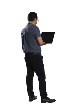 Businessman standing and typing on laptop with transparent background