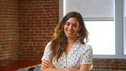 Portrait Of Businesswoman In Office Standing By Window