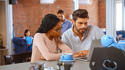 Businessman and Businesswoman Have Informal Meeting In Office Coffee Bar