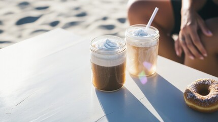 Refreshing cold brew coffee drinks on a beachside picnic table with vegan donuts during a summer afternoon