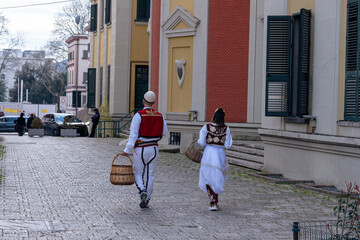 Young couple walking in the city with traditional albanian costumes