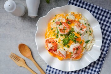 Thai style scrambled eggs with shrimps on rice, creamy omelet with shrimps on rice