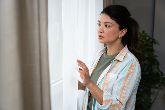 Mental health, woman and nervous of thinking in home with failure, paranoid and regret trauma. Overthinking, person and anxiety in house for ptsd, isolation and victim phobia with stress or wondering